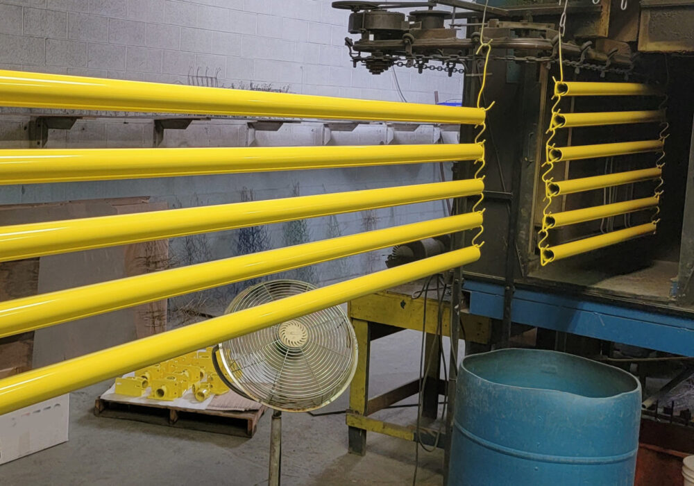 Safety Yellow powder coated hand rails exiting Girard, PA oven. ERIEPOWDERCOATING serves the Tri-State Area of Ohio, Pennsylvania And New York